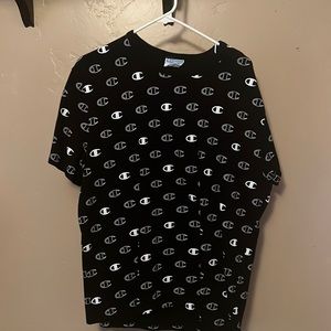 ITS A CHAMPION T SHIRT ITS IN LARGE, BLACK AND WHITE WITH WHITE CHAMPION LOGOS
